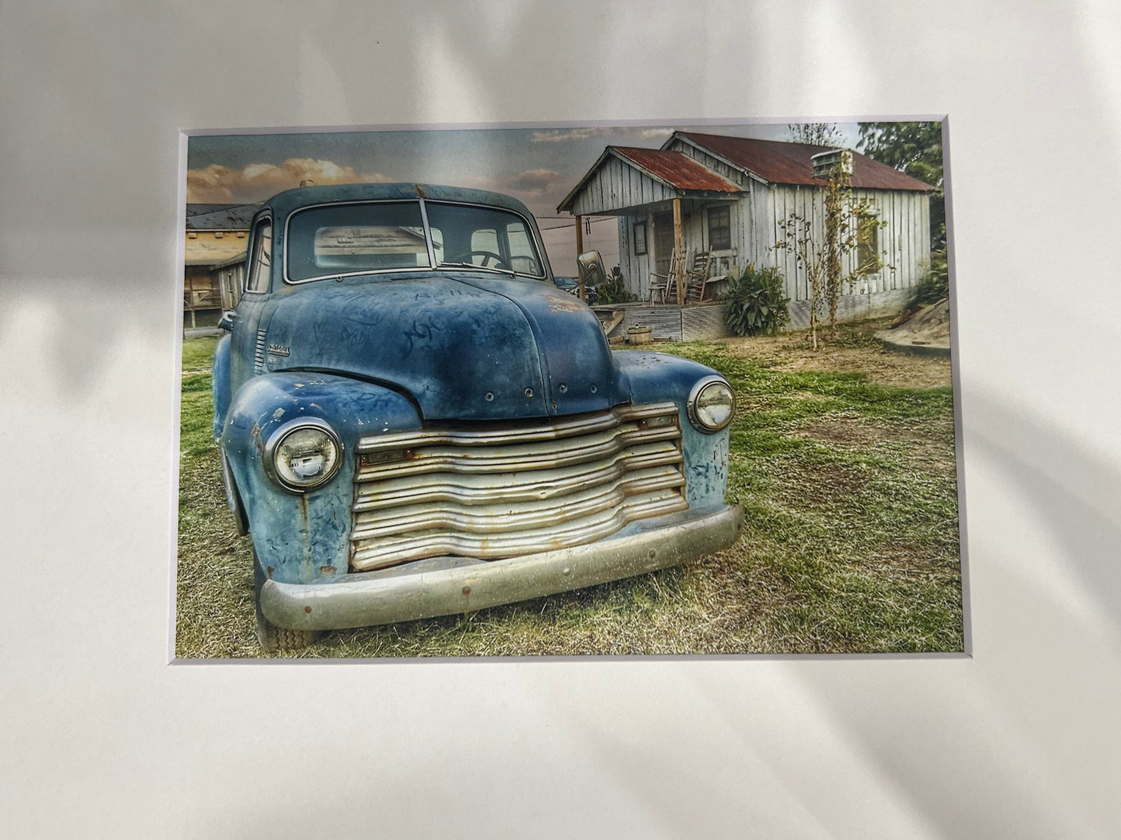 Close-up of a vintage truck's grill with a blurred background